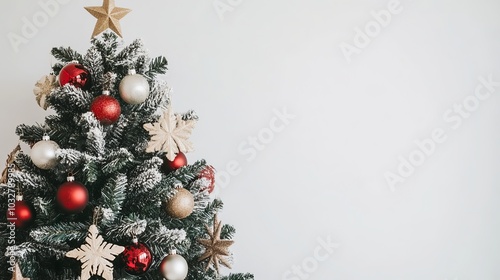 A Christmas tree decorated with New Year decorations against a white background.