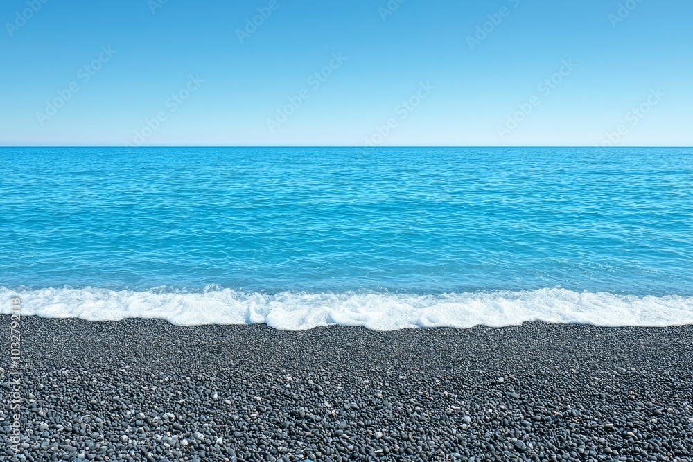 Black Pebble Beach with a White-Capped Blue Ocean Black Pebble Beach with a White-Capped Blue Ocean
