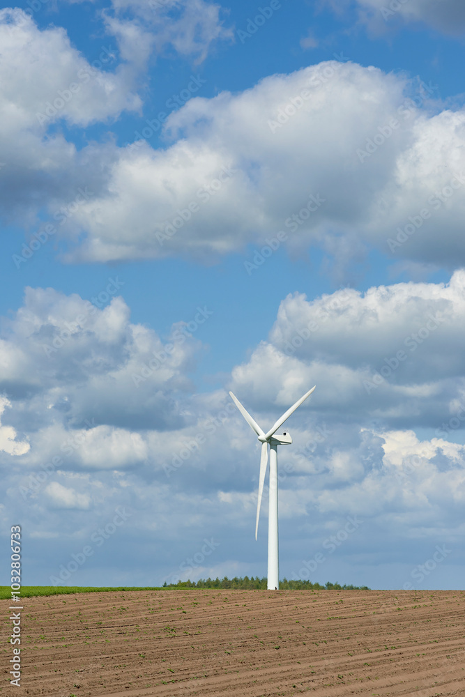 Fototapeta premium Earth, clouds and landscape with wind turbine for renewable energy outdoor to produce electricity. Nature, recycling and sky with windmill in nature environment for conservation or power supply