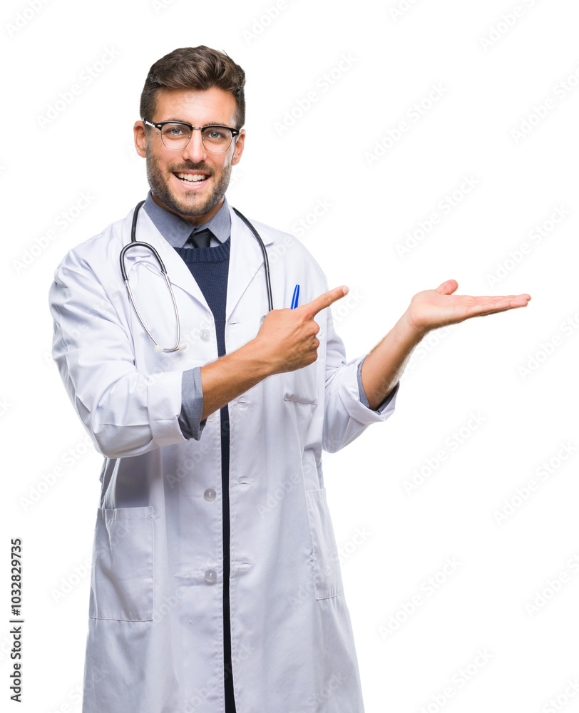 Young handsome doctor man over isolated background amazed and smiling to the camera while presenting with hand and pointing with finger. Young handsome doctor man over isolated background amazed and smiling to the camera while presenting with hand and pointing with finger.