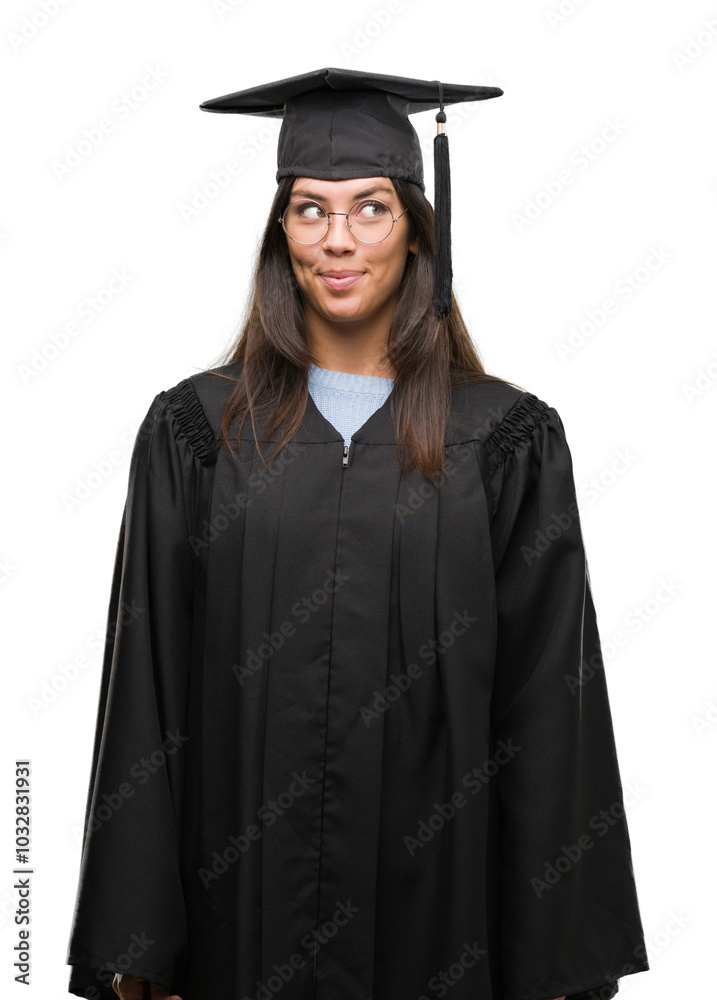 Young hispanic woman wearing graduated cap and uniform smiling looking side and staring away thinking. Young hispanic woman wearing graduated cap and uniform smiling looking side and staring away thinking.