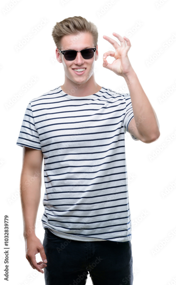 Young handsome blond man wearing sunglasess doing ok sign with fingers, excellent symbol Young handsome blond man wearing sunglasess doing ok sign with fingers, excellent symbol