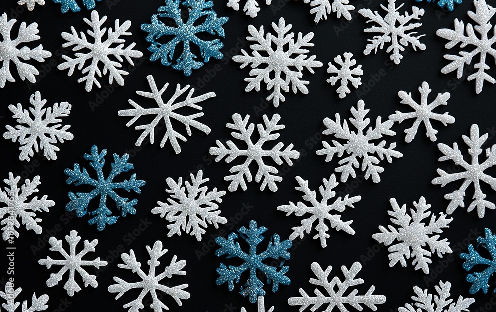 Decorative snowflakes in blue and white arranged on a dark background for winter-themed crafts or holiday decorations Decorative snowflakes in blue and white arranged on a dark background for winter-themed crafts or holiday decorations