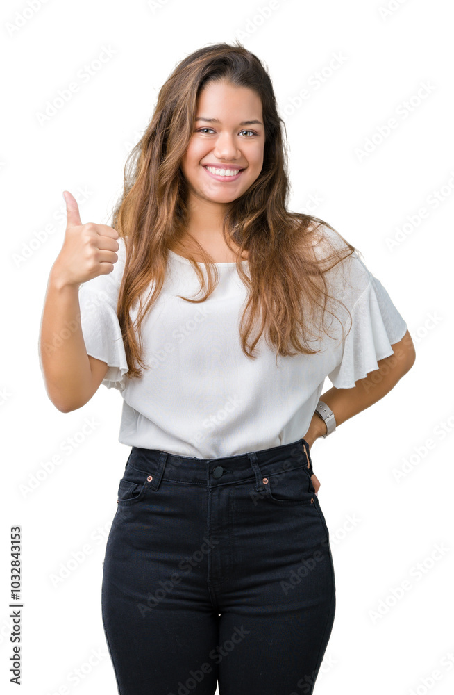 Young beautiful brunette business woman over isolated background doing happy thumbs up gesture with hand. Approving expression looking at the camera showing success. Young beautiful brunette business woman over isolated background doing happy thumbs up gesture with hand. Approving expression looking at the camera showing success.
