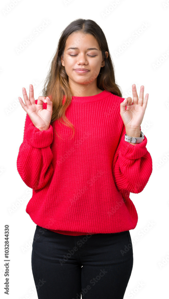 Young beautiful brunette woman wearing red winter sweater over isolated background relax and smiling with eyes closed doing meditation gesture with fingers. Yoga concept. Young beautiful brunette woman wearing red winter sweater over isolated background relax and smiling with eyes closed doing meditation gesture with fingers. Yoga concept.