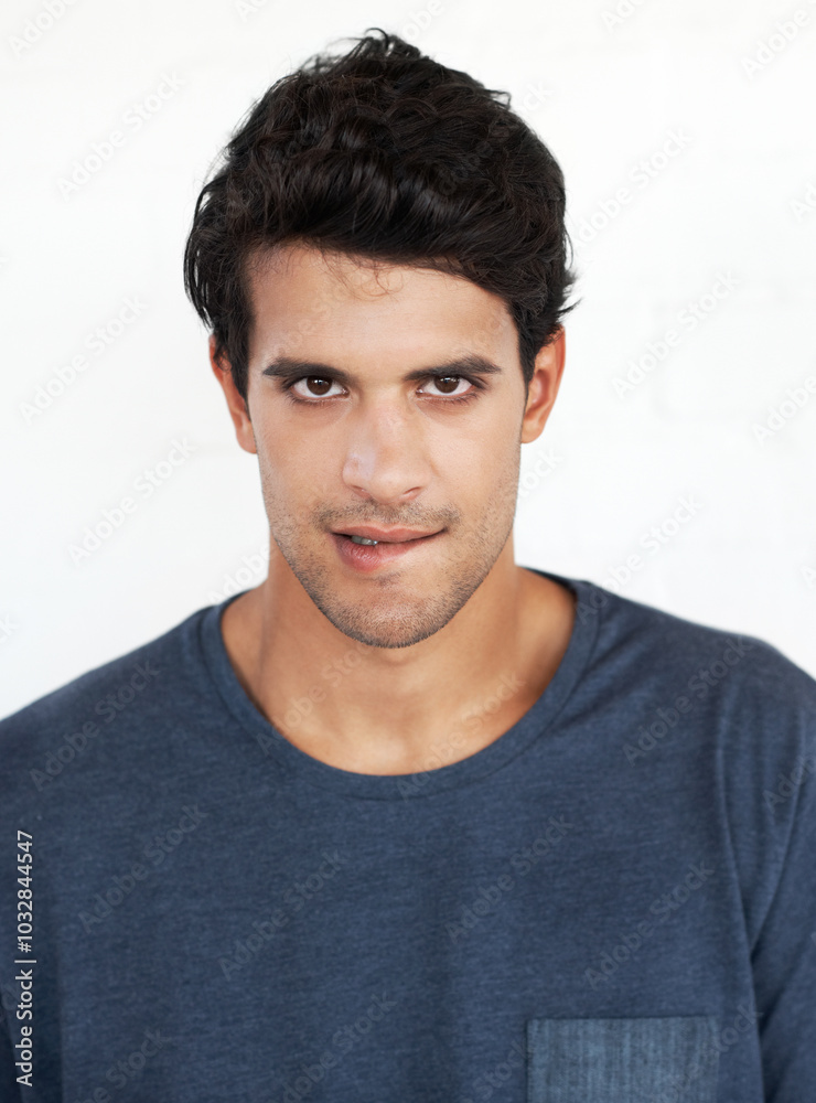 Obraz premium Portrait, proud and man in studio, fashion and serious with outfit, trendy and stylish with clothes. White background, student and model with tshirt, confident and person in college, cool and Cuba