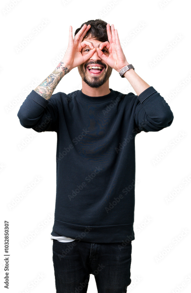 Young handsome man over isolated background doing ok gesture like binoculars sticking tongue out, eyes looking through fingers. Crazy expression. Young handsome man over isolated background doing ok gesture like binoculars sticking tongue out, eyes looking through fingers. Crazy expression.