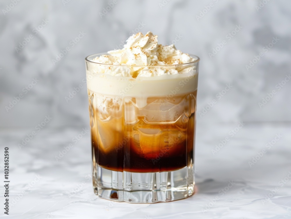 A white Russian cocktail in a rocks glass with cream on a white background A white Russian cocktail in a rocks glass with cream on a white background