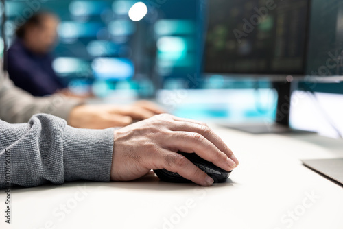 Cyber security experts in a governmental hacking room working on securing networks. Hackers focusing on malware detection, cyber operations and protection against digital mercenaries.