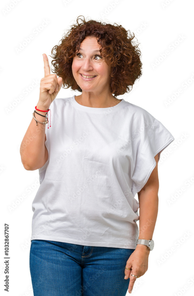 Beautiful middle ager senior woman wearing white t-shirt over isolated background cheerful with a smile of face pointing with hand and finger up to the side with happy and natural expression on face Beautiful middle ager senior woman wearing white t-shirt over isolated background cheerful with a smile of face pointing with hand and finger up to the side with happy and natural expression on face