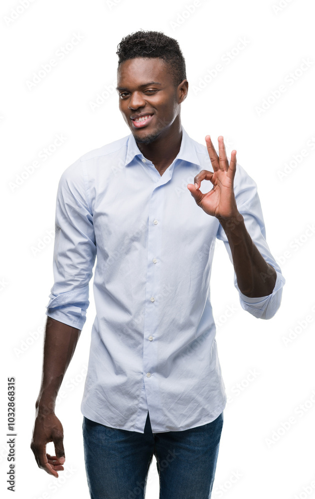 Young african american man wearing a shirt doing ok sign with fingers, excellent symbol Young african american man wearing a shirt doing ok sign with fingers, excellent symbol