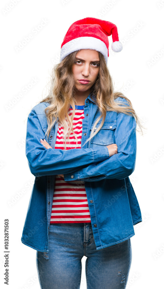 Beautiful young blonde woman wearing christmas hat over isolated background skeptic and nervous, disapproving expression on face with crossed arms. Negative person. Beautiful young blonde woman wearing christmas hat over isolated background skeptic and nervous, disapproving expression on face with crossed arms. Negative person.