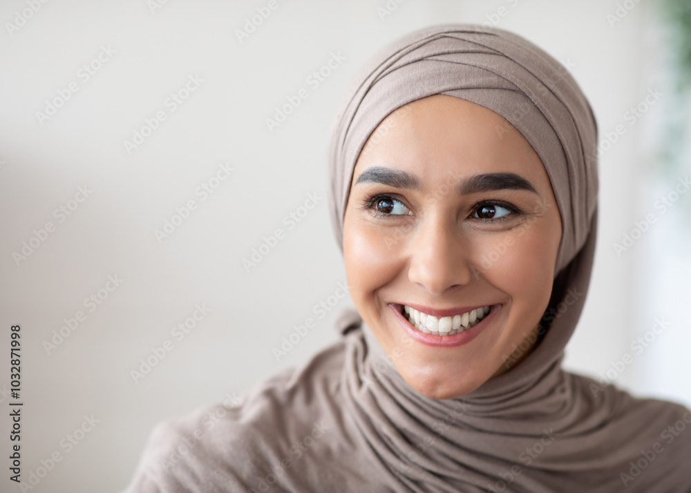 Closeup portrait of cheerful muslim lady in stylish headscarf looking at copy space, panorama. Happy arab woman in hijab watching advertisement and smiling. Job opportunities for arab women Closeup portrait of cheerful muslim lady in stylish headscarf looking at copy space, panorama. Happy arab woman in hijab watching advertisement and smiling. Job opportunities for arab women