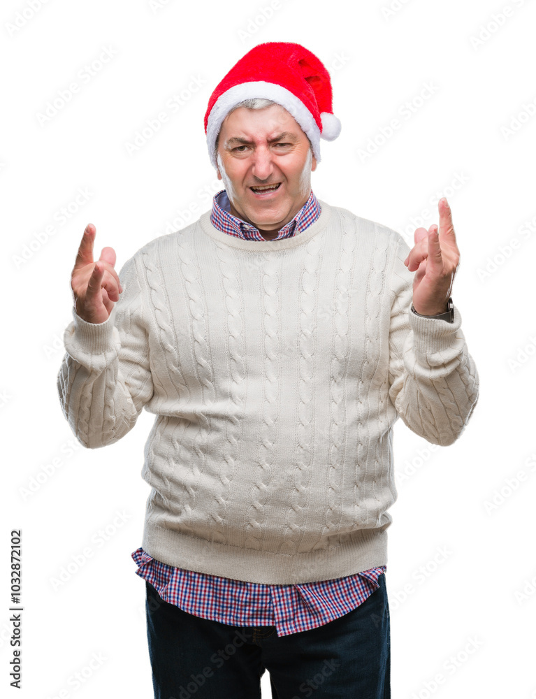 Handsome senior man wearing christmas hat over isolated background shouting with crazy expression doing rock symbol with hands up. Music star. Heavy concept. Handsome senior man wearing christmas hat over isolated background shouting with crazy expression doing rock symbol with hands up. Music star. Heavy concept.
