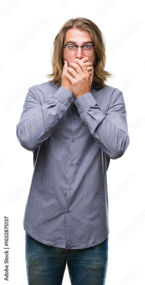 Young handsome man with long hair wearing bow tie over isolated background shocked covering mouth with hands for mistake. Secret concept.