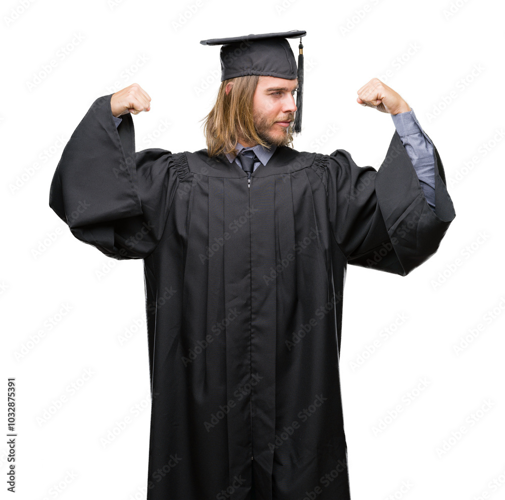 Young handsome graduated man with long hair over isolated background showing arms muscles smiling proud. Fitness concept. Young handsome graduated man with long hair over isolated background showing arms muscles smiling proud. Fitness concept.