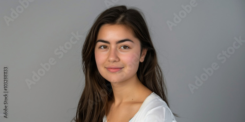 Portrait of a Young Woman with Long Hair Against a Neutral Background