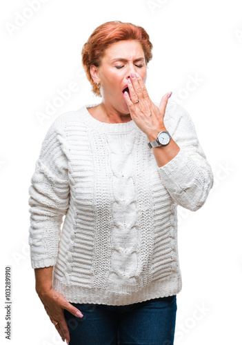 Atrractive senior caucasian redhead woman wearing winter sweater over isolated background bored yawning tired covering mouth with hand. Restless and sleepiness.