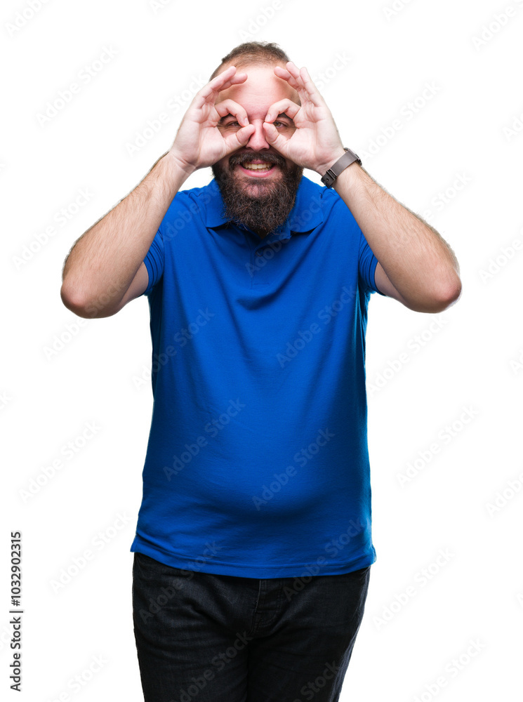 Young caucasian hipster man wearing blue shirt over isolated background doing ok gesture like binoculars sticking tongue out, eyes looking through fingers. Crazy expression. Young caucasian hipster man wearing blue shirt over isolated background doing ok gesture like binoculars sticking tongue out, eyes looking through fingers. Crazy expression.
