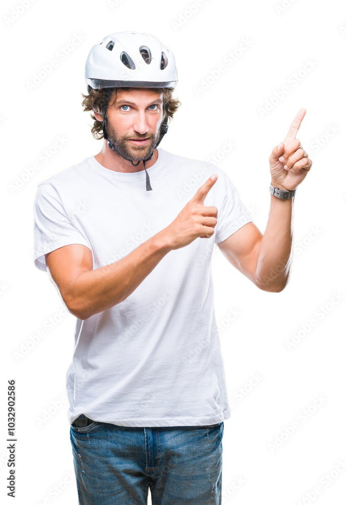 Handsome hispanic cyclist man wearing safety helmet over isolated background smiling and looking at the camera pointing with two hands and fingers to the side. Handsome hispanic cyclist man wearing safety helmet over isolated background smiling and looking at the camera pointing with two hands and fingers to the side.