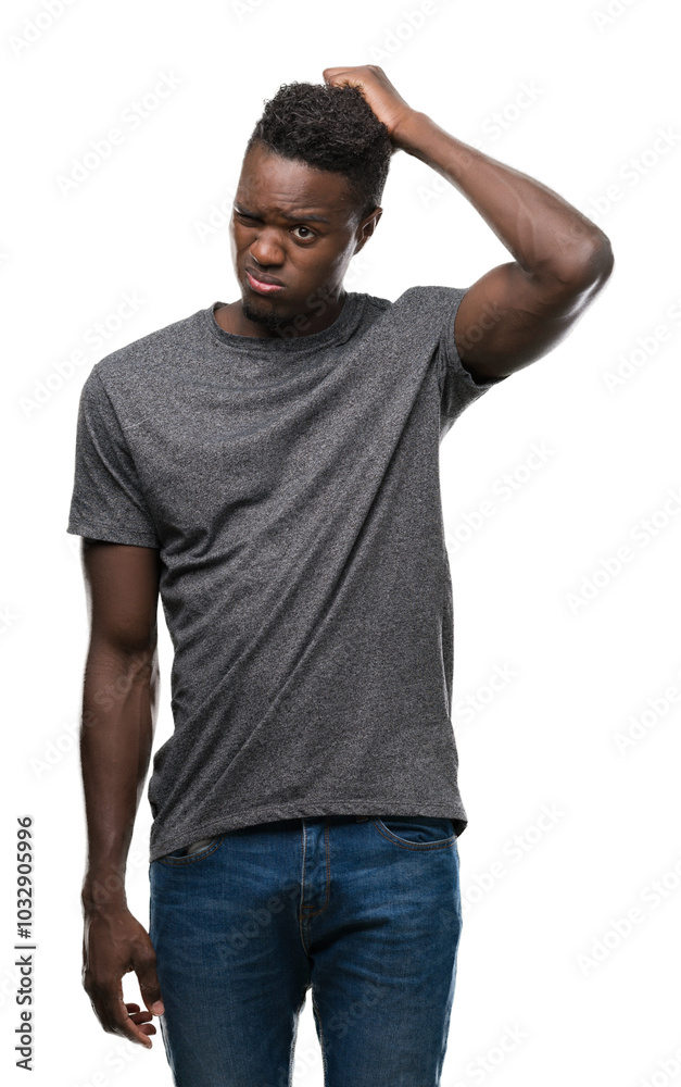 Young african american man wearing grey t-shirt confuse and wonder about question. Uncertain with doubt, thinking with hand on head. Pensive concept. Young african american man wearing grey t-shirt confuse and wonder about question. Uncertain with doubt, thinking with hand on head. Pensive concept.