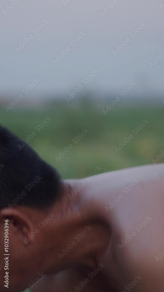 bare-chested farmer works alone in the crop field with a hoe in vietnam bare-chested farmer works alone in the crop field with a hoe in vietnam
