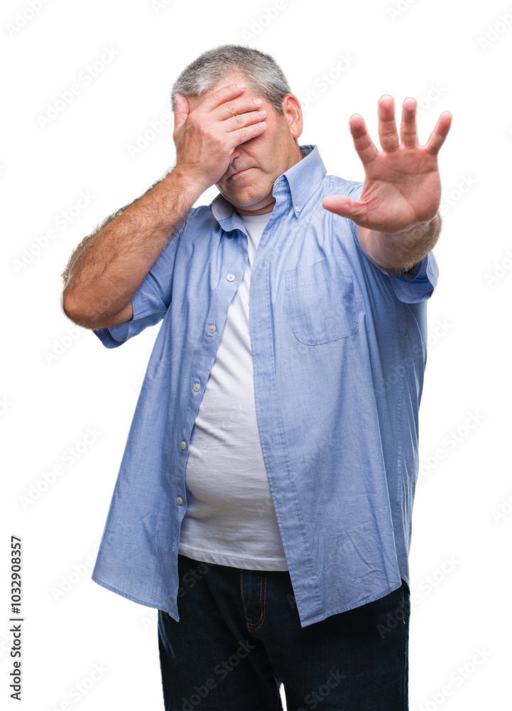 Handsome senior man over isolated background covering eyes with hands and doing stop gesture with sad and fear expression. Embarrassed and negative concept. Handsome senior man over isolated background covering eyes with hands and doing stop gesture with sad and fear expression. Embarrassed and negative concept.