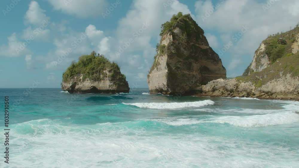Clear blue waves crash against the towering cliffs covered with lush vegetation, creating a serene natural seascape. Clear blue waves crash against the towering cliffs covered with lush vegetation, creating a serene natural seascape.