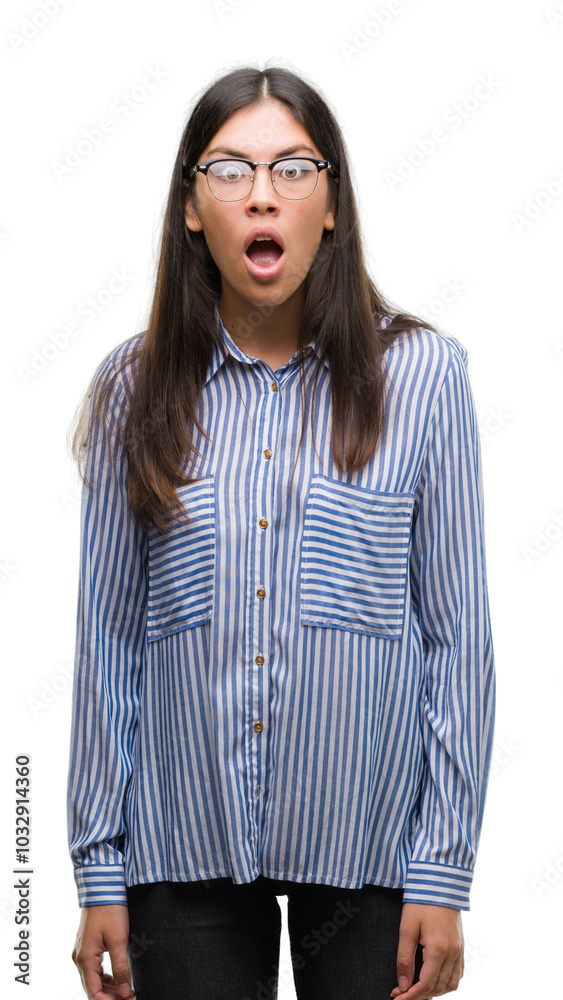 Young beautiful hispanic business woman afraid and shocked with surprise expression, fear and excited face.