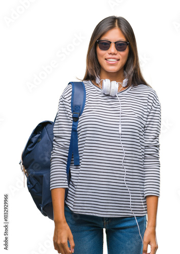 Young asian student woman wearing headphones and backpack over isolated background with a happy and cool smile on face. Lucky person.
