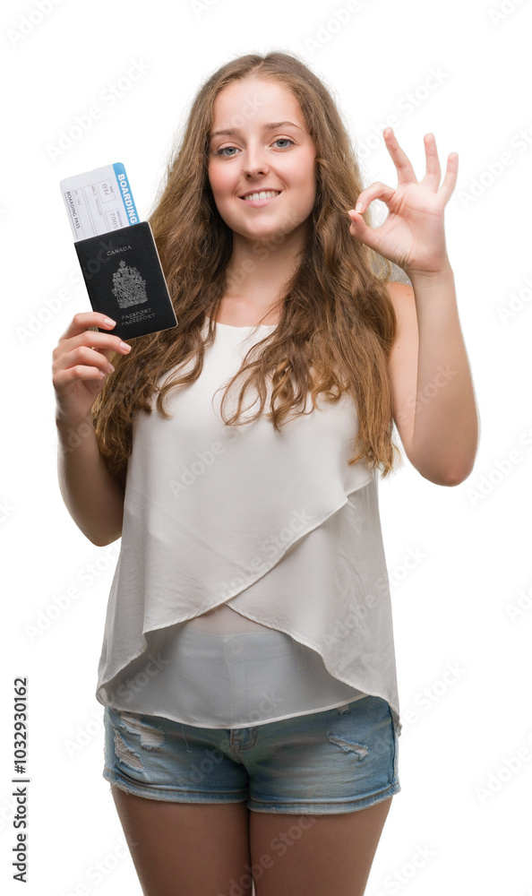 Young blonde woman holding passport of canada and boarding pass doing ok sign with fingers, excellent symbol Young blonde woman holding passport of canada and boarding pass doing ok sign with fingers, excellent symbol