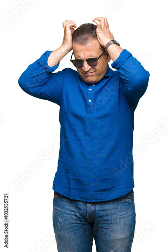 Middle age arab man wearing sunglasses over isolated background suffering from headache desperate and stressed because pain and migraine. Hands on head.