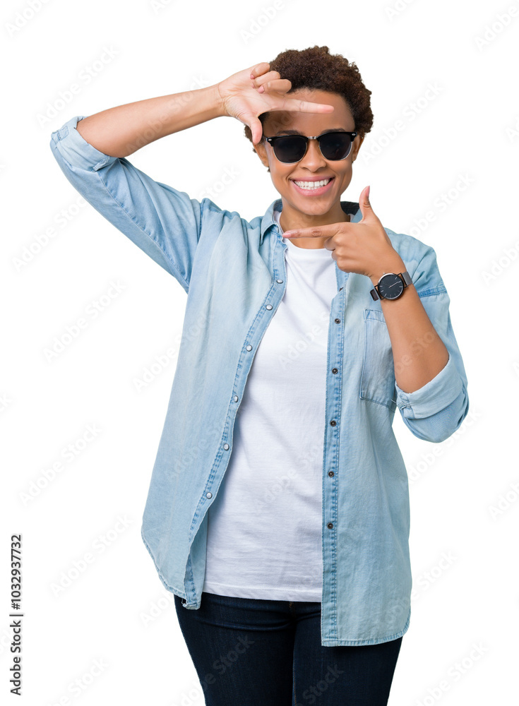 Beautiful young african american woman wearing sunglasses over isolated background smiling making frame with hands and fingers with happy face. Creativity and photography concept.