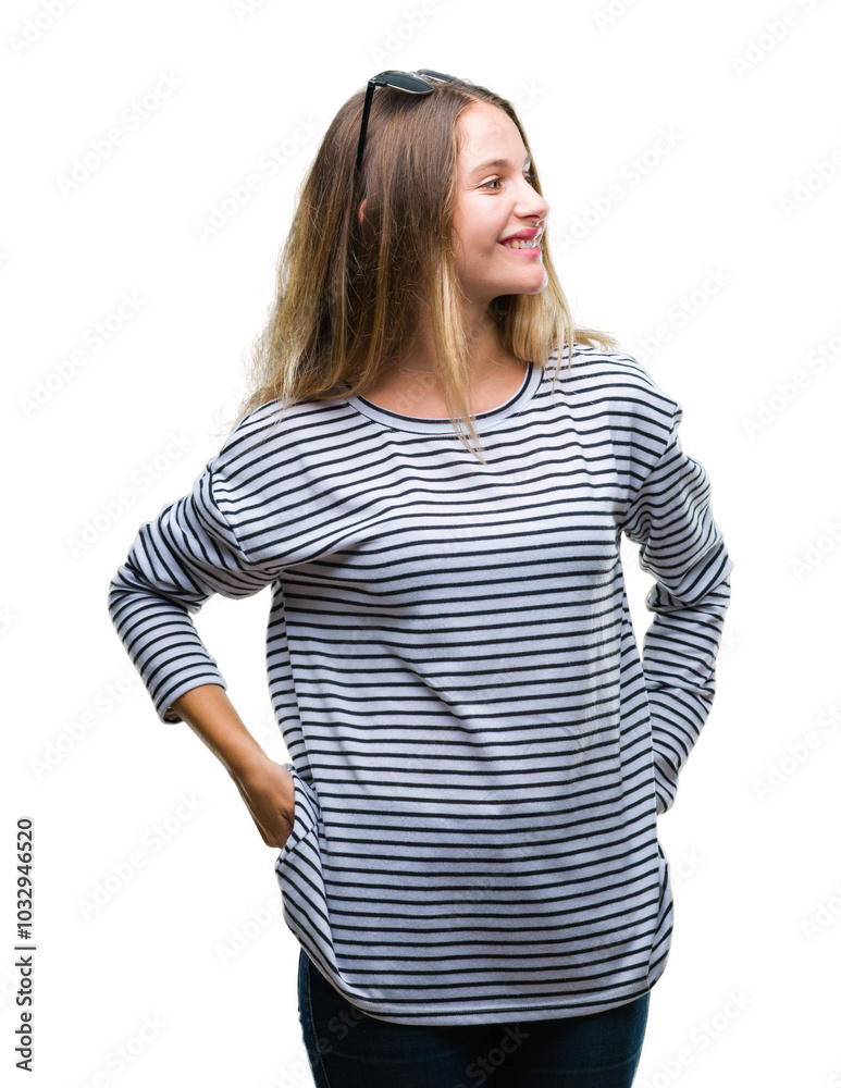 Young beautiful blonde woman wearing sunglasses over isolated background looking away to side with smile on face, natural expression. Laughing confident. Young beautiful blonde woman wearing sunglasses over isolated background looking away to side with smile on face, natural expression. Laughing confident.