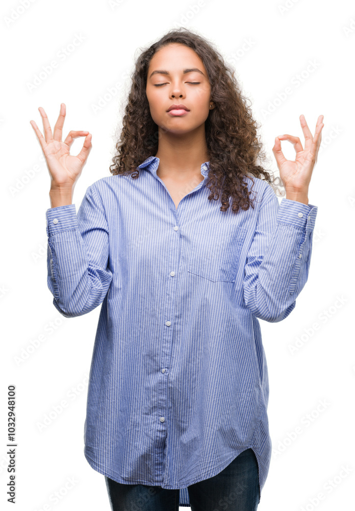 Young hispanic business woman relax and smiling with eyes closed doing meditation gesture with fingers. Yoga concept. Young hispanic business woman relax and smiling with eyes closed doing meditation gesture with fingers. Yoga concept.