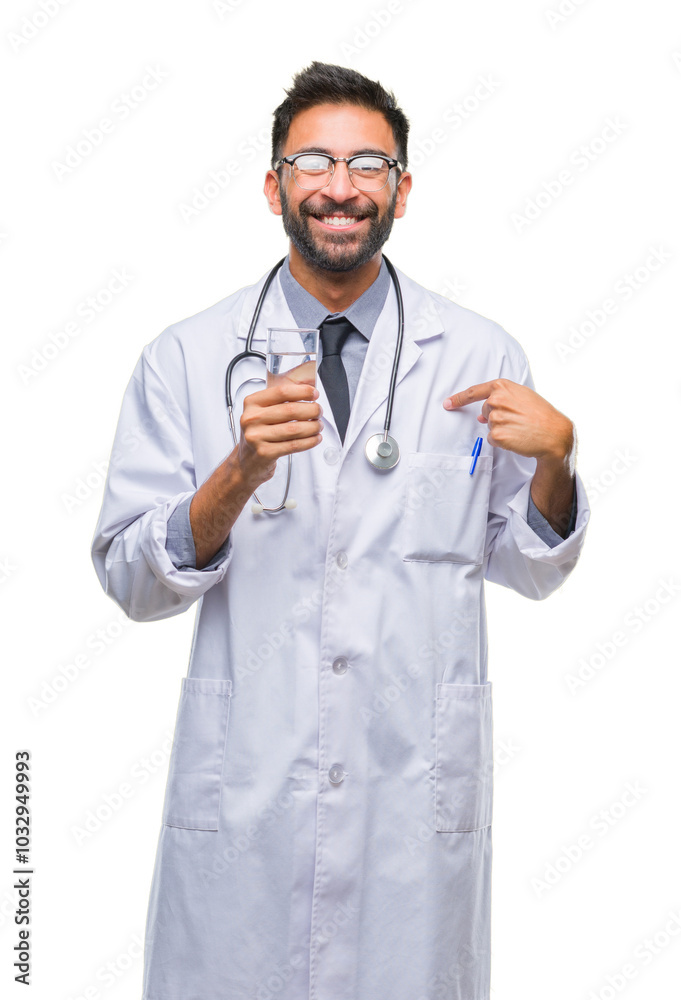 Adult hispanic doctor man drinking glass of water over isolated background with surprise face pointing finger to himself Adult hispanic doctor man drinking glass of water over isolated background with surprise face pointing finger to himself