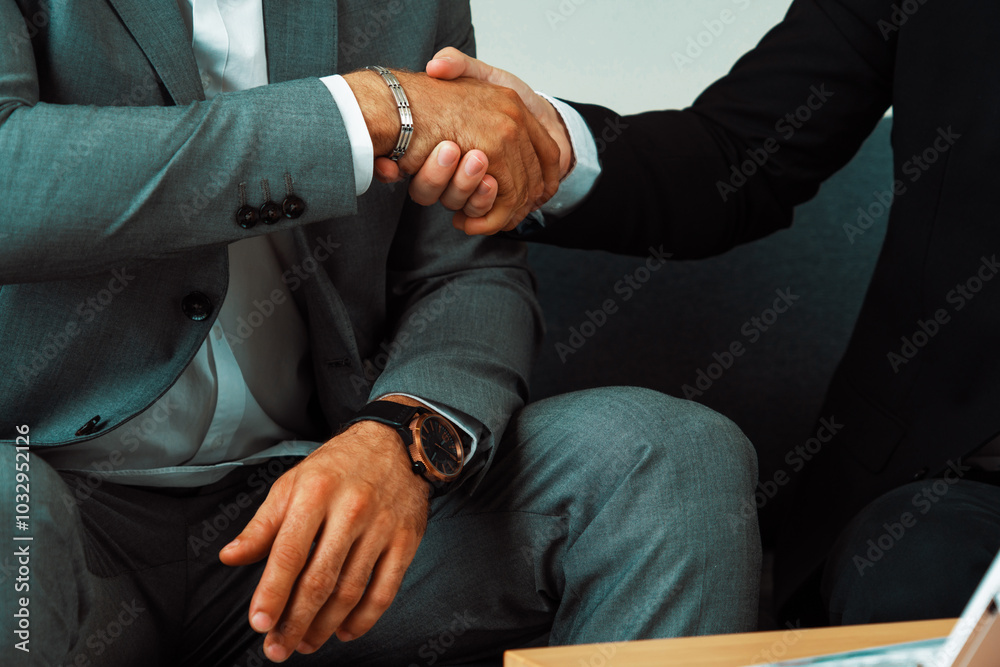 Obraz premium Businessman handshake with another businessman partner in modern workplace office. People corporate business deals concept. uds