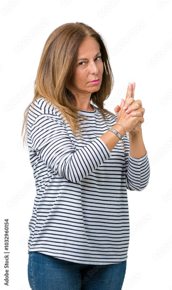 Beautiful middle age woman wearing stripes sweater over isolated background Holding symbolic gun with hand gesture, playing killing shooting weapons, angry face Beautiful middle age woman wearing stripes sweater over isolated background Holding symbolic gun with hand gesture, playing killing shooting weapons, angry face
