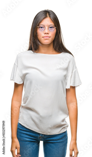 Young asian woman wearing glasses over isolated background with serious expression on face. Simple and natural looking at the camera.