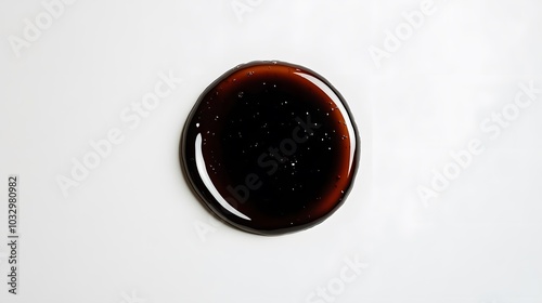 Puddle of soy sauce isolated on a white background. 