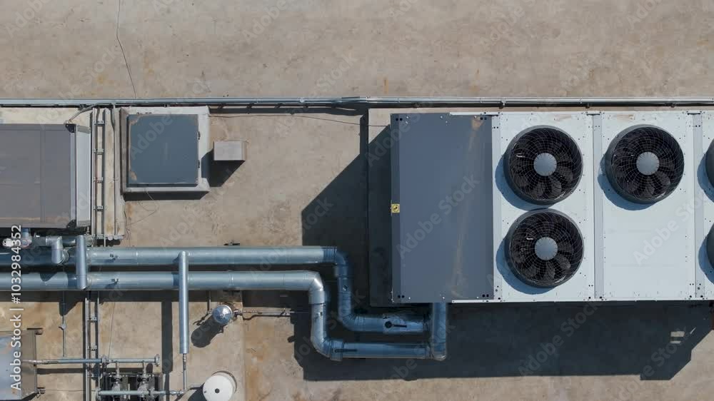air conditioning industrial in top of a building roof, ac unit and pipe tubes with ventilation fans