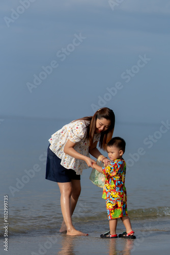 Mother playing with son on the beach