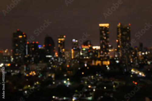 Blurred photo of skyscrapers in Bangkok cityscape at twilight time.