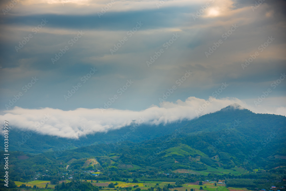 Naklejka premium Beautiful Mountain landscape foggy windy mountain range green landscape asian farm. Amazing Landscape mountain green field meadow white cloud blue sky on sunrise. Countryside sunlight heaven scenery