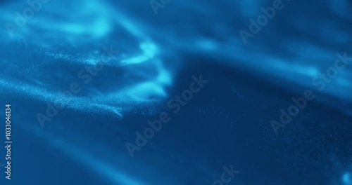 Blue abstract particle effect with flowing motion, resembling underwater or cosmic scenes. Ideal for video loops, technology, sci-fi, relaxation, and motion graphics.