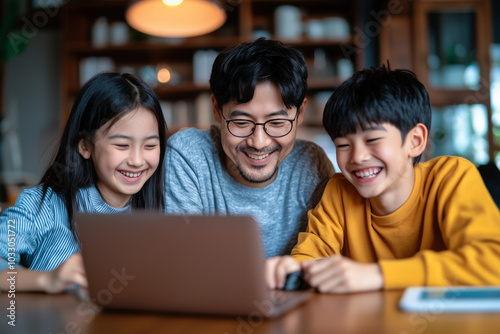 Father with Two Children Laughing While Using Laptop Concept of Family Bonding and Technology