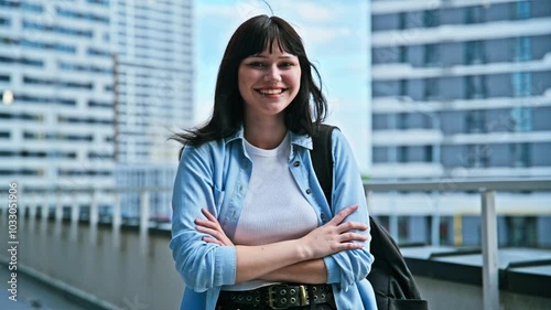 Portrait young confident female college student with backpack, crossed arms, outdoors