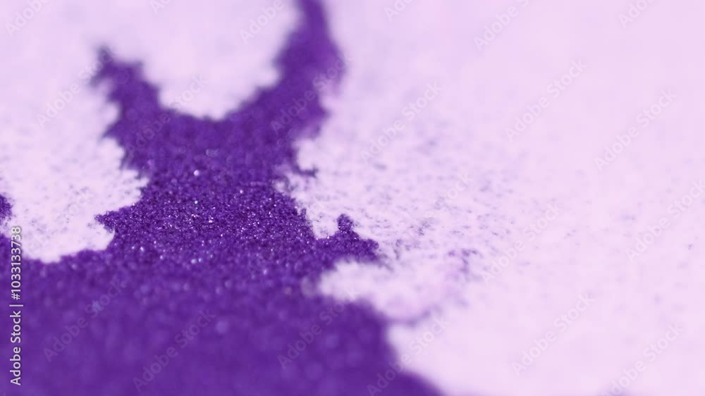 Sparkling ink splatter. Wet particles. Defocused white purple color shimmering fluid stain wave motion bokeh light abstract art background. Sparkling ink splatter. Wet particles. Defocused white purple color shimmering fluid stain wave motion bokeh light abstract art background.