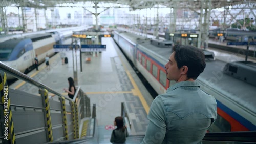 Wallpaper Mural Australian Man Traveler Riding Escalator Down to Platforms of Seoul Train Station, View Of Railway Tracks and Locomotives - over shoulder view Torontodigital.ca