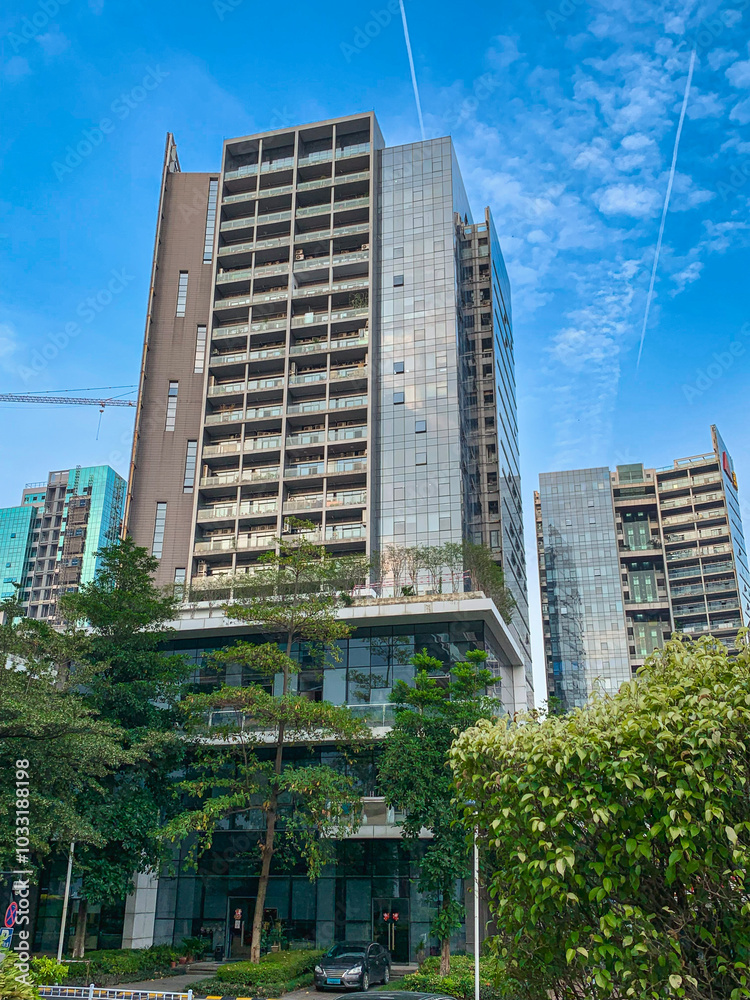 Obraz premium A low angle view of office building skyscraper inside a corporate park in downtown Guangzhou, China.